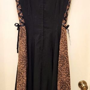 Bettie Page black and leopard print dress with side tie accent.